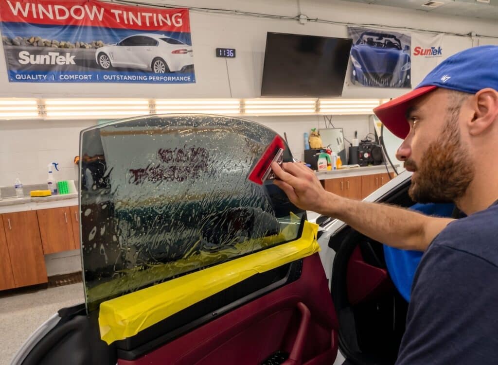 Technician installing ceramic window tint